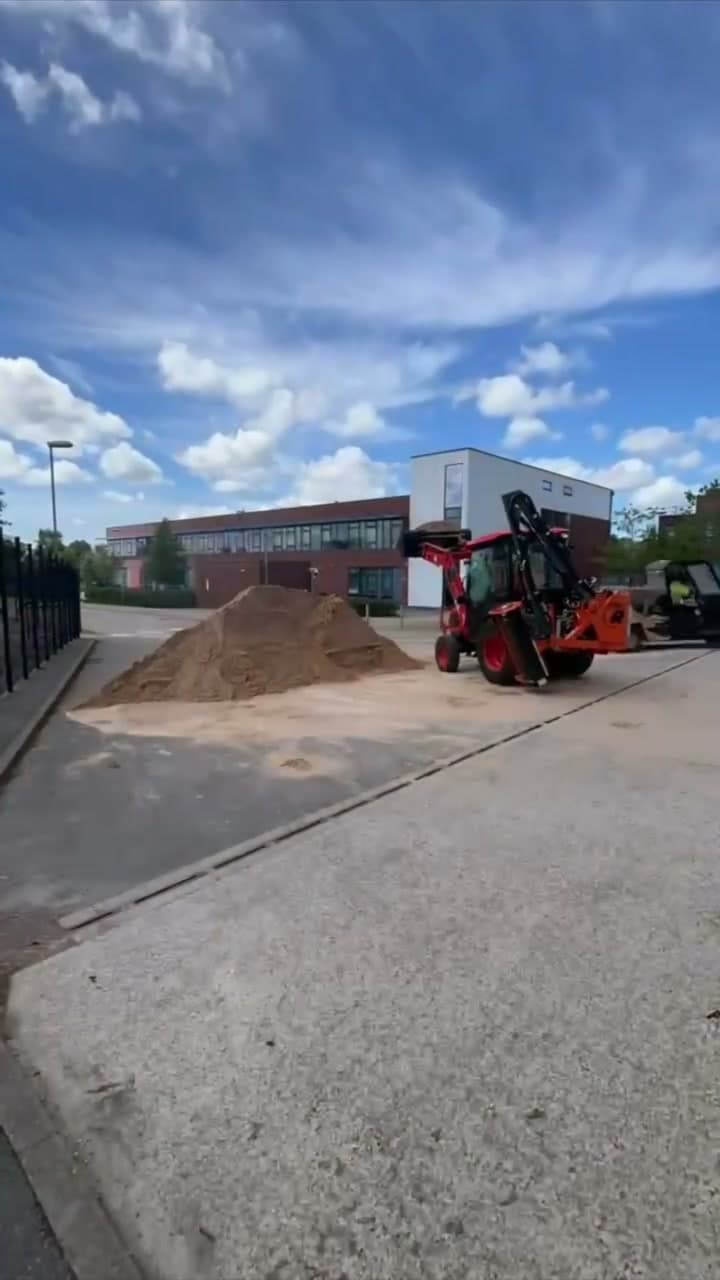 JG Groundcare tractor moving topsoil on a school site