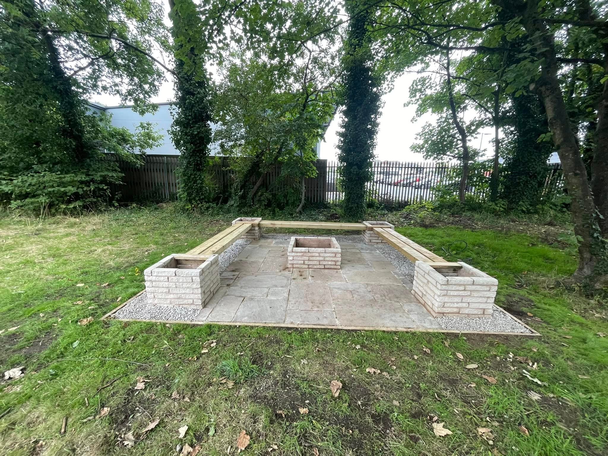 Finished stone planters built into a landscaped area