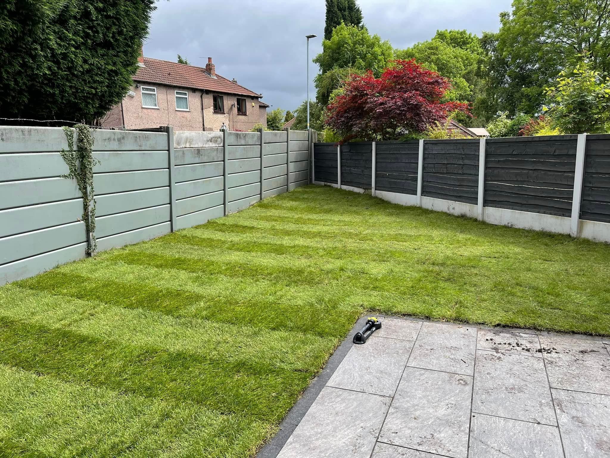 Freshly striped lawn beside new composite fencing