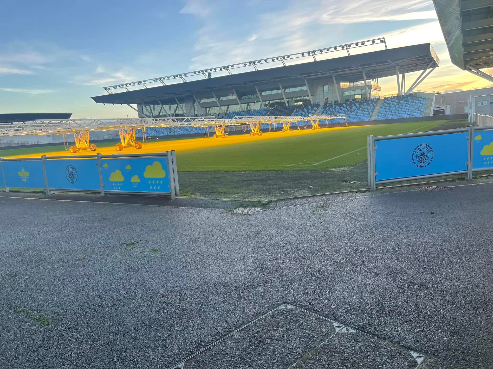 Sports ground with a covered stand and a freshly painted perimeter